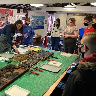 Young people attending a lino printing workshop