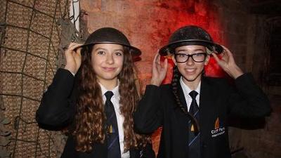 School children dressed up in metal hats