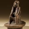 Spong Man - a dark brown decorative ceramic pot lid with a seated figure moulded on top